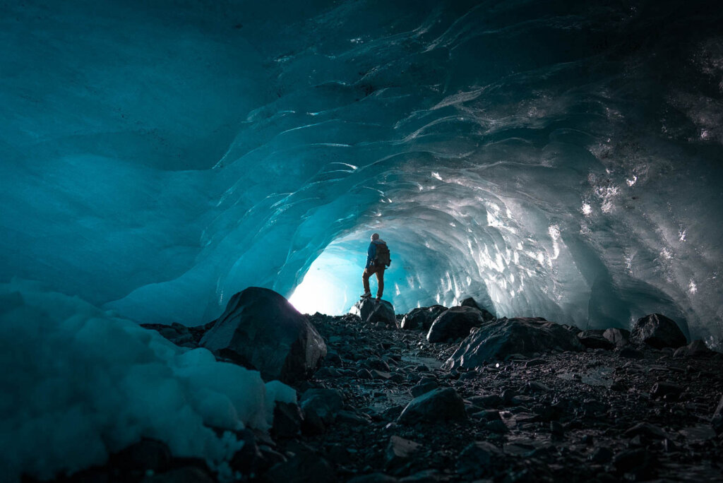 Jeven Dovey standing in the entrance of an ice cave