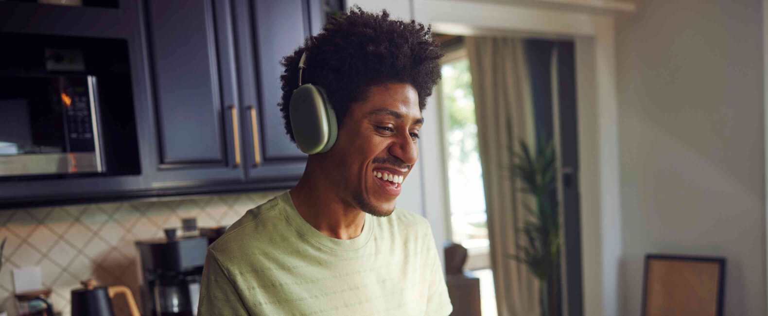 Man Wearing Headphones Smiling Laughing And Gesturing