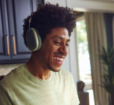 Man Wearing Headphones Smiling Laughing And Gesturing